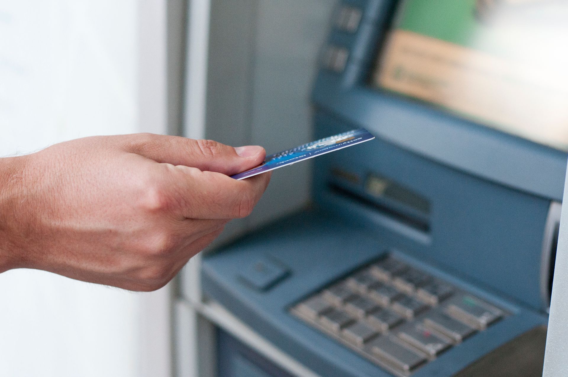 hand-inserting-atm-card-into-bank-machine-withdraw-money-businessman-men-hand-puts-credit-card-into-atm_%281%29